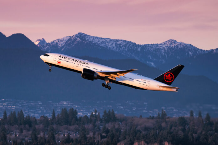 Air Canada Boeing 777 taking off from Vancouver International Airport during sunset. Date: Feb 11, 2022