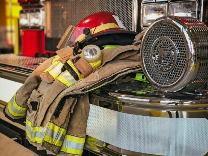 Firefighters uniform on bumper of truck