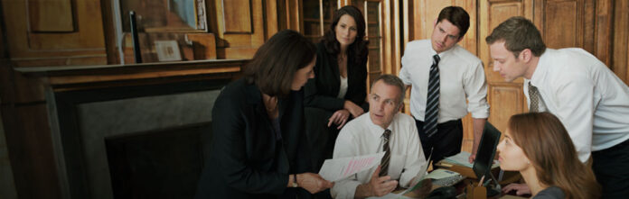 lawyers sitting at boardroom table in a corporate legal department