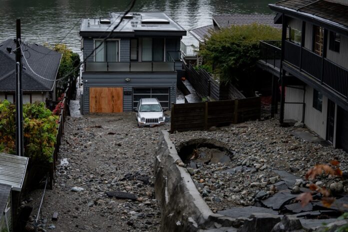 Homes surrounded by debris following B.C. atmospheric river.