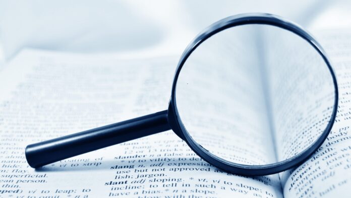 Magnifying glass on a dictionary