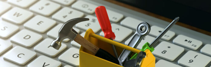 Mini toolbox sitting on a keyboard depicting contract lifecycle management tools