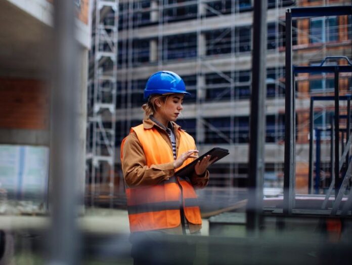 Woman with tech on a construction site