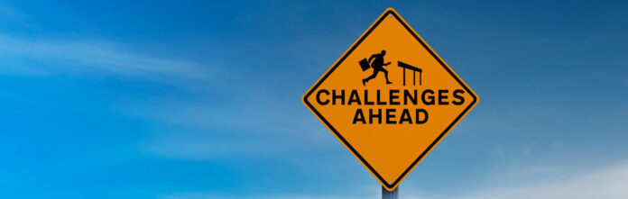 The word, challenges, on a road sign with a blue sky depicting law operations challenges in the future